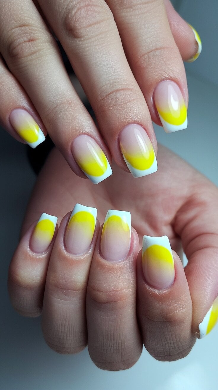Nails featuring a yellow gradient with white tips